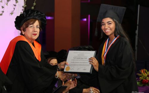 Graduanda recibe Diploma de manos de la Viceministra de Educación.
