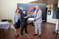 Entrega de reconocimiento al estudiante Holden Clark por el Dr. Aguilar.