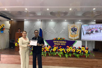 Dra. Marta Moreno, Subdirectora de Vida Universitaria entrega certificado a Vasco Medina, estudiante del Centro. 