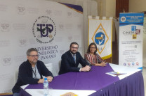 El expositor de la conferencia, Mgtr. Nicolás Remedi, se observa en el centro, junto a la Dra. Nuvia Martez y al Dr. Humberto Álvarez, sentados en la mesa principal.
